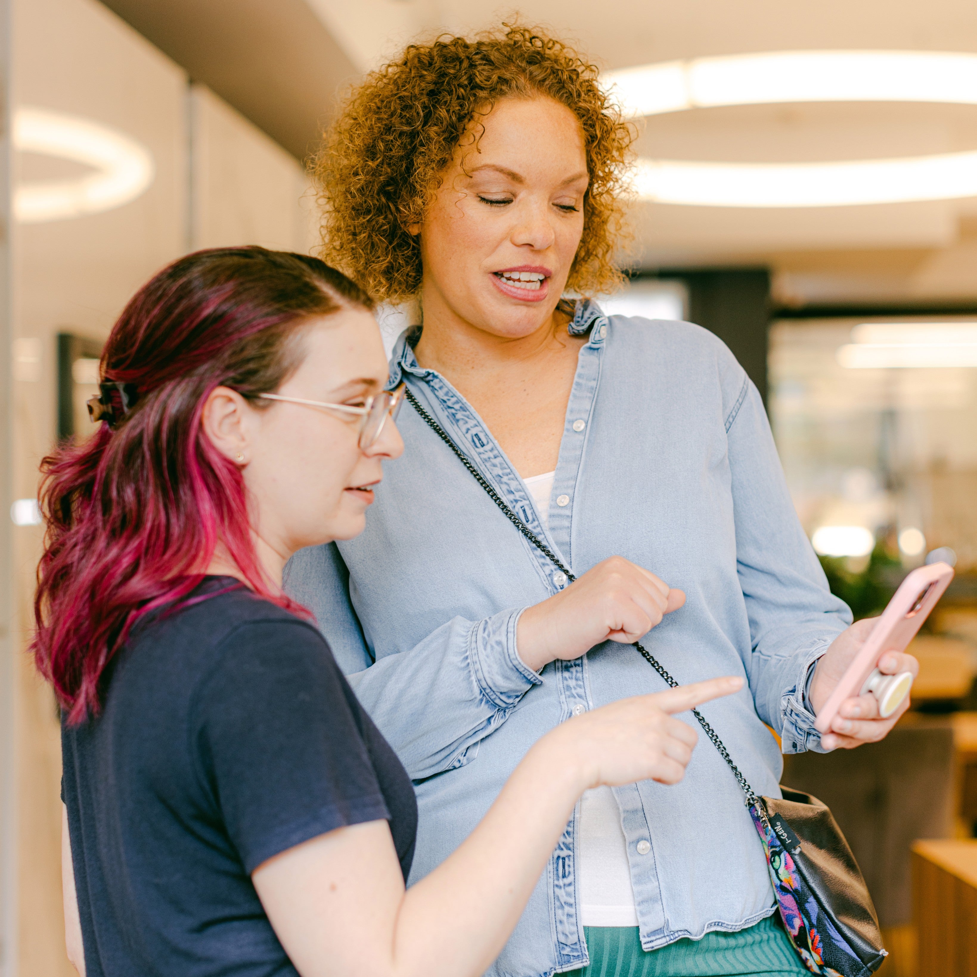Two women looking at phone