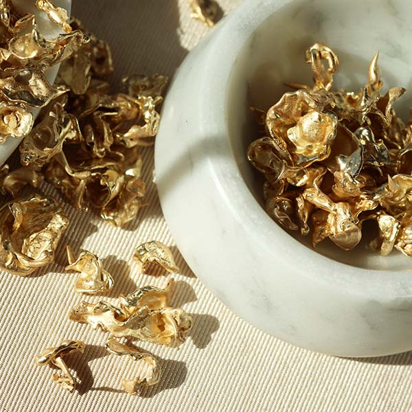 Fairmined Certified gold with recycled gold in a bowl and table